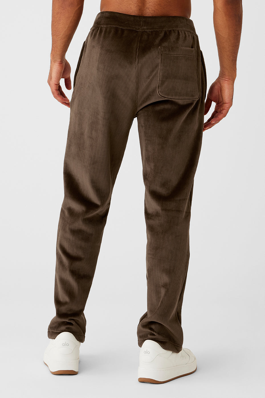 Side view of plush sweatpants featuring zippered pockets.
