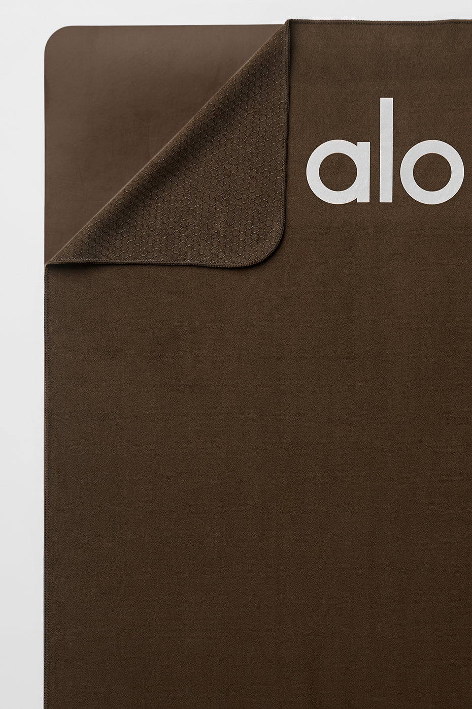Close-up showing silicone grip pattern on back of espresso yoga towel