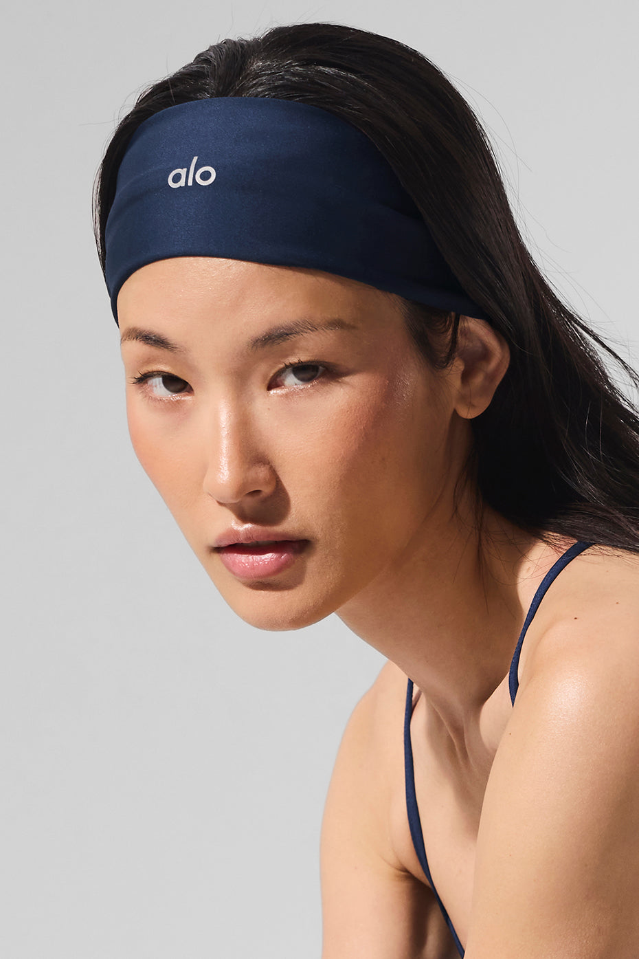 Navy Airlift headband worn during a workout, highlighting its moisture-wicking fabric