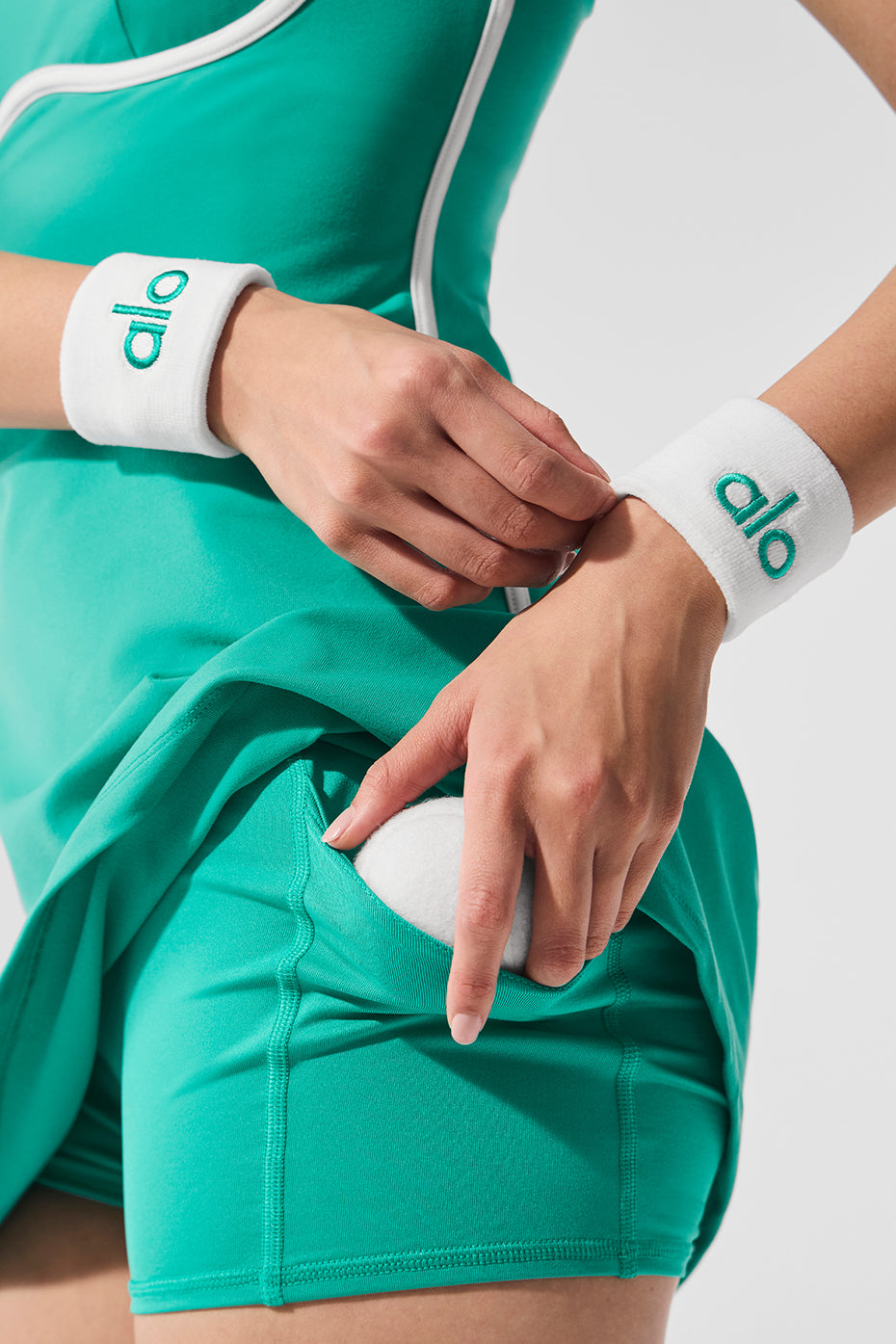 Spruce green terry cloth wristband worn during outdoor activities