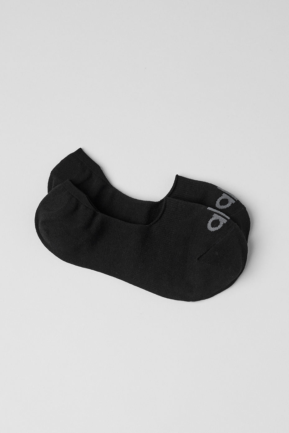 Close-up of sleek no-show compression socks in black.