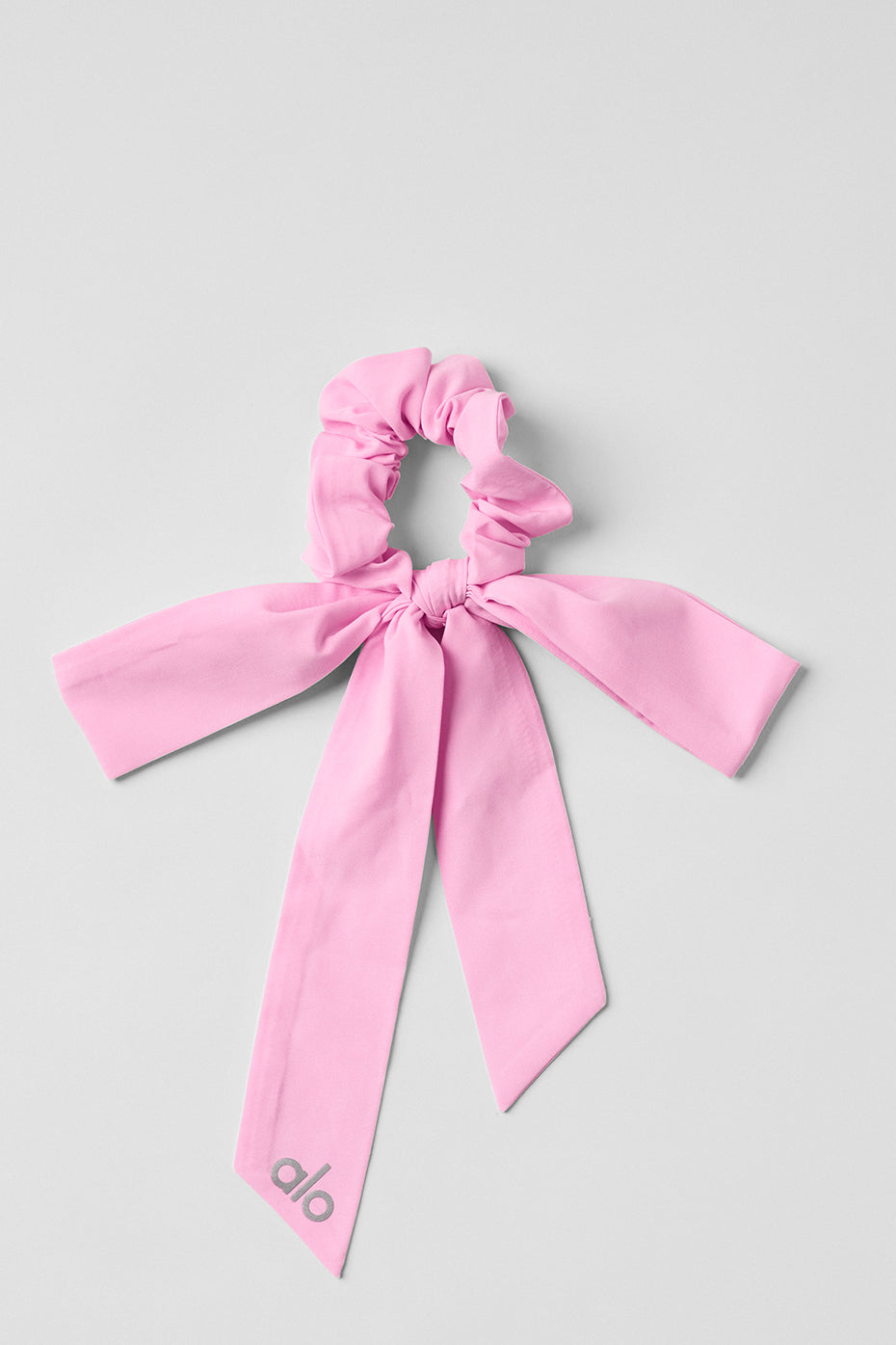 Close-up of pink silk scrunchie tied around a ponytail for bridal hair accessories use