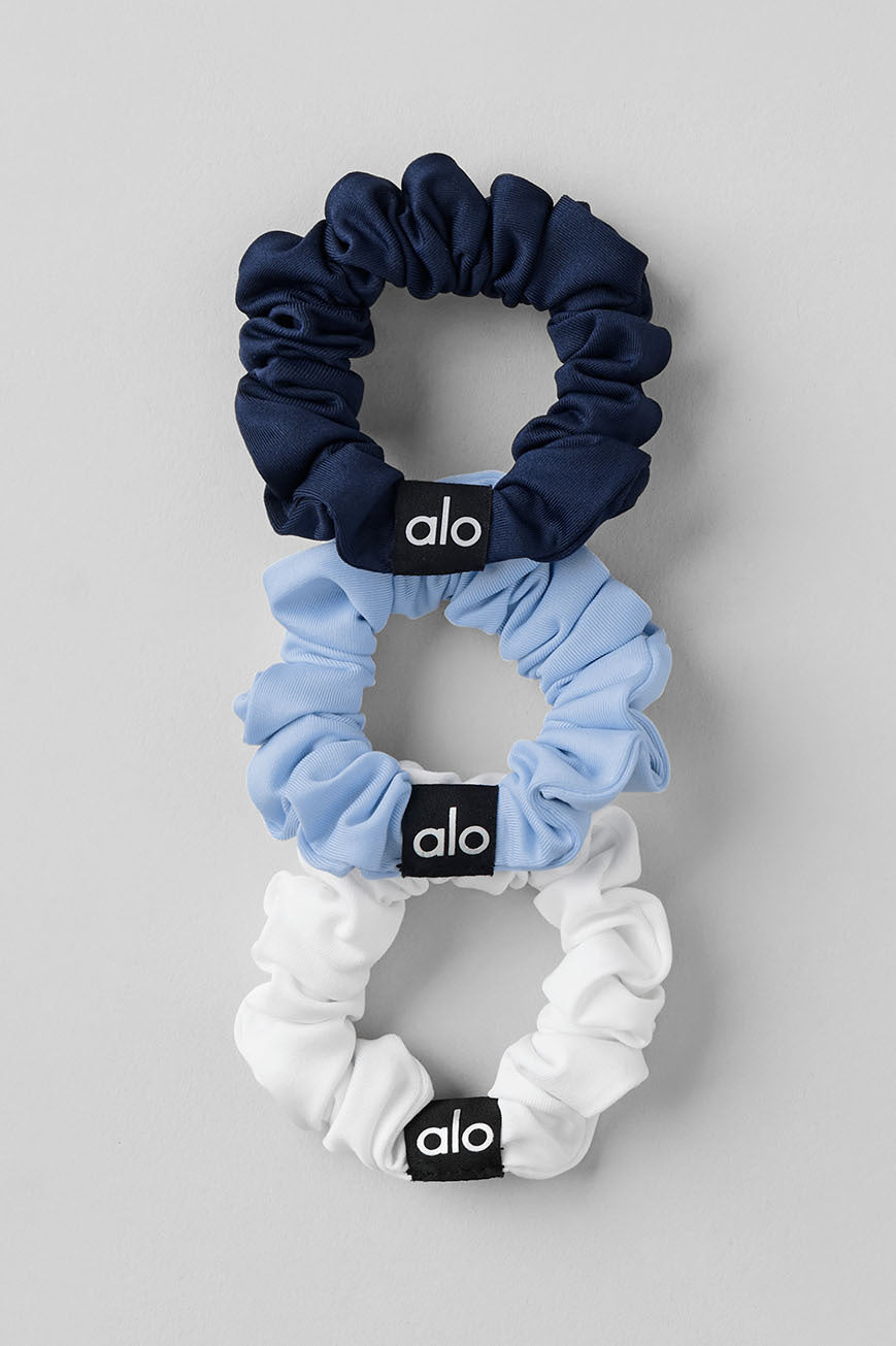Mini silk scrunchies in seashell blue, navy, and white colors, perfect for casual or formal styles