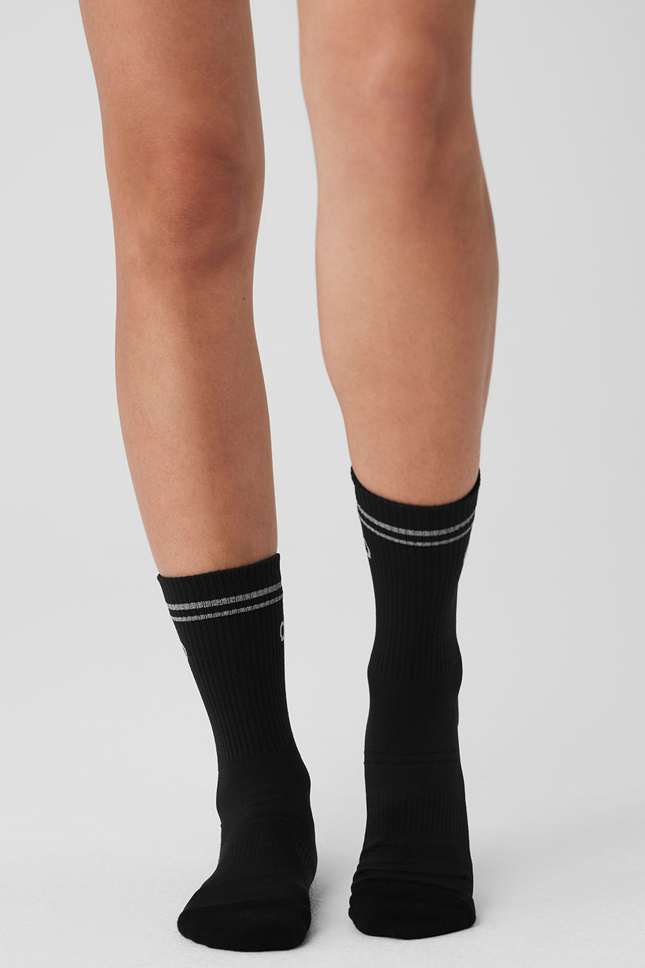 Detailed view of the reflective ALO logo on Unisex Performance Socks.