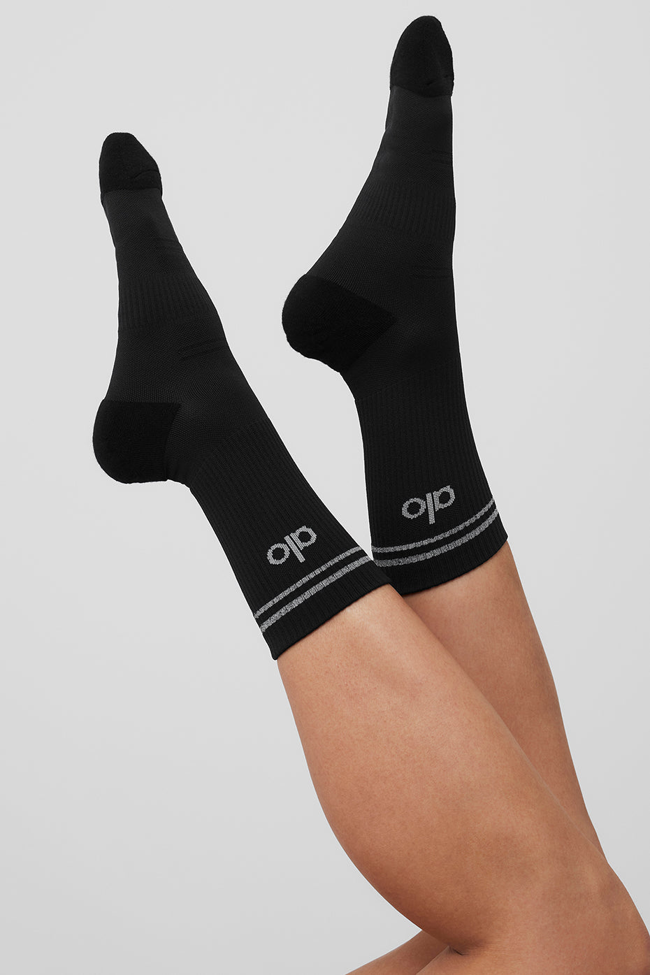 Model wearing black performance socks during a workout for optimal comfort.