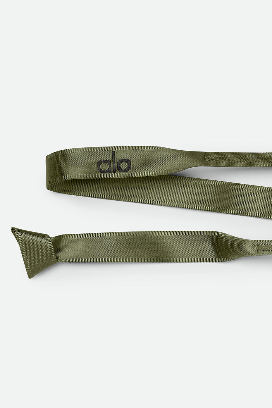 Yoga strap being used for deep stretches and support in a yoga class.