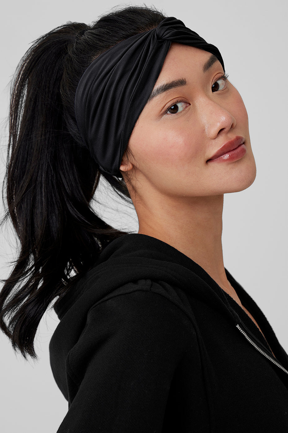 Front view of the black sueded headband worn during yoga practice.