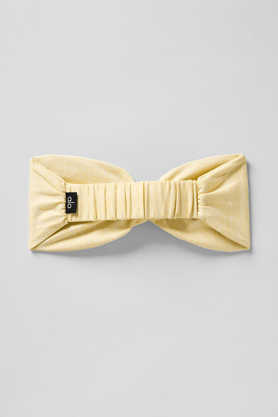Headband displayed on a fitness mat, ideal for workout accessories.