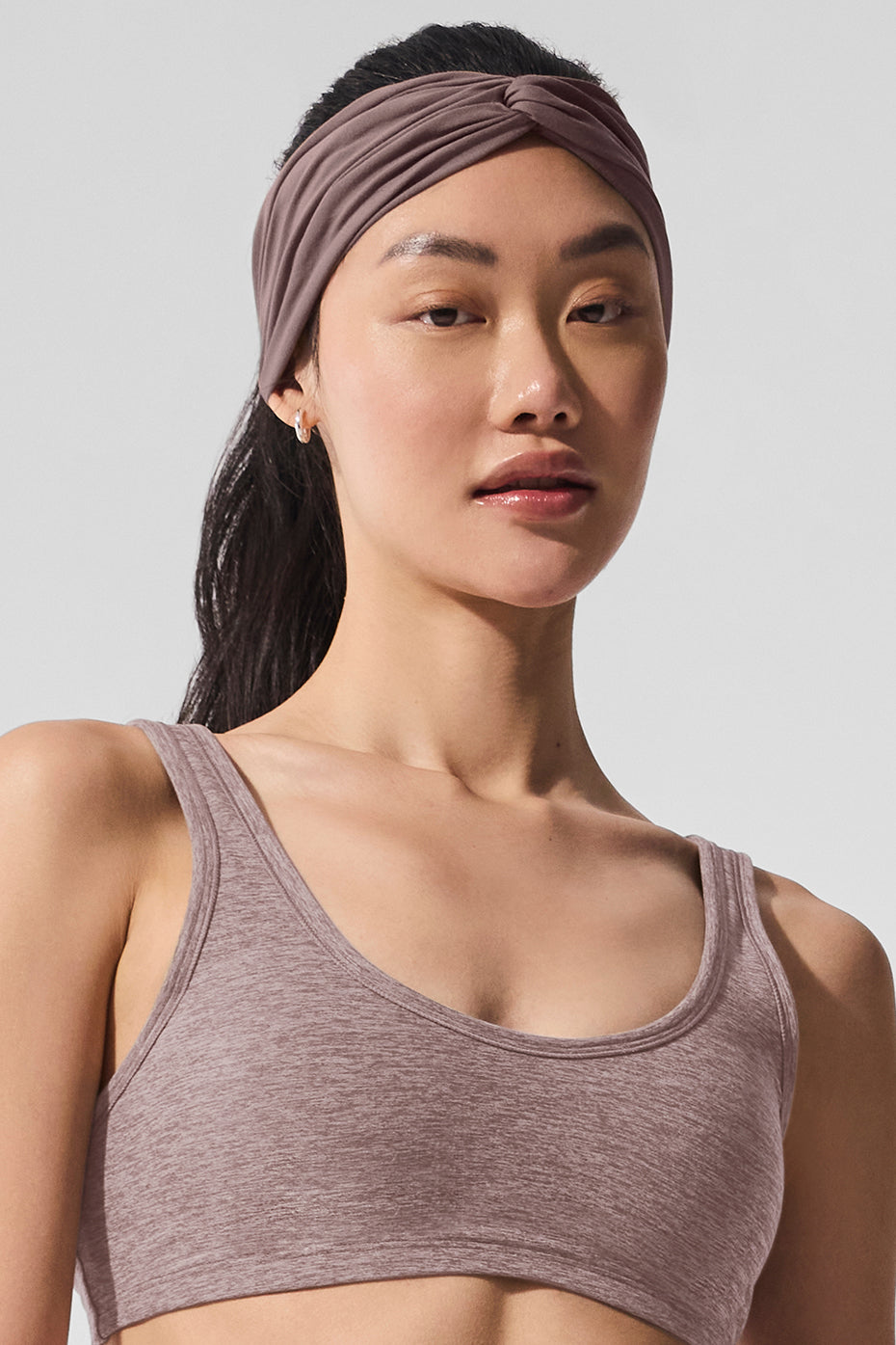Model wearing headband during outdoor yoga in Santa Monica park