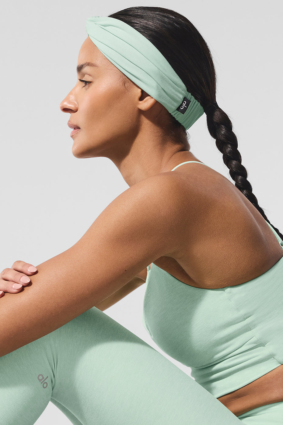 Spearmint Alosoft yoga headband with cinched detail worn during hot yoga