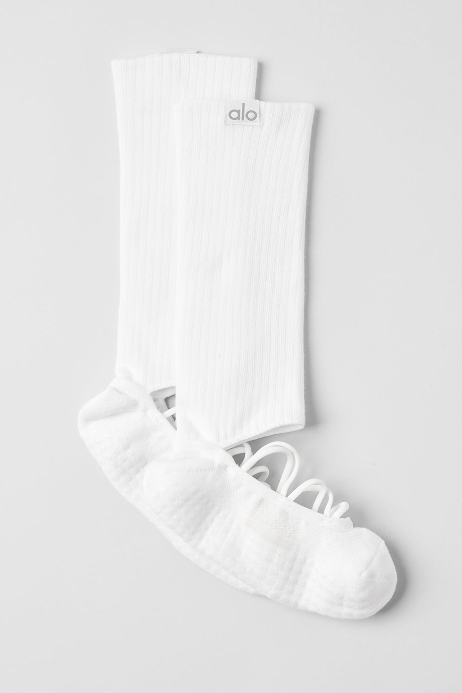 Model wearing white grip socks during a pilates class.