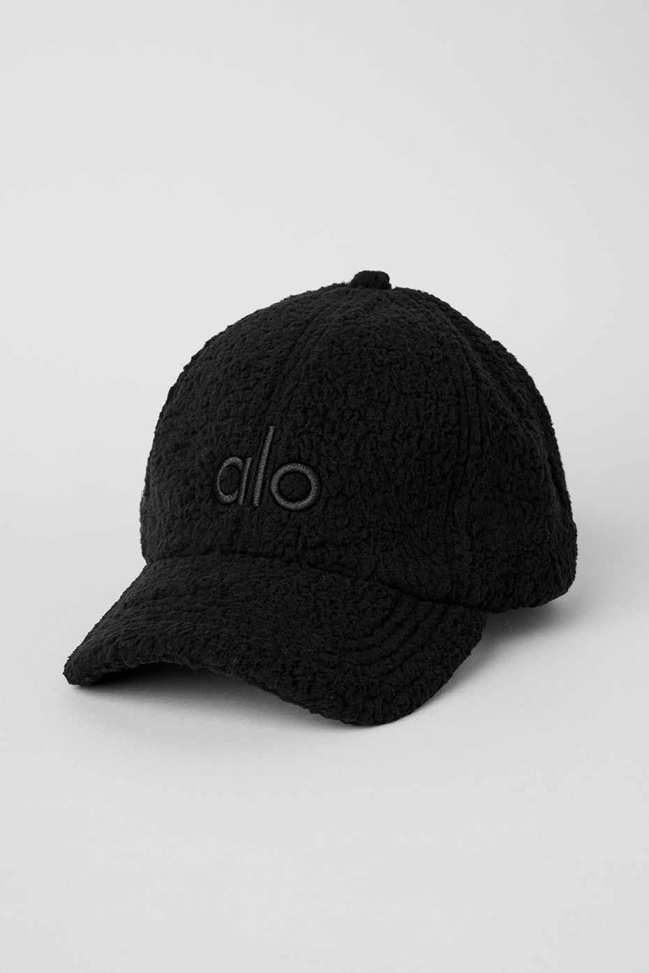 Front view of the Micro Sherpa Alo Cap in black, showcasing the embroidered logo.