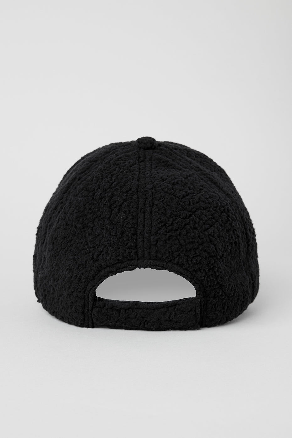 Side angle of the Micro Sherpa Alo Cap, emphasizing its soft sherpa fabric.