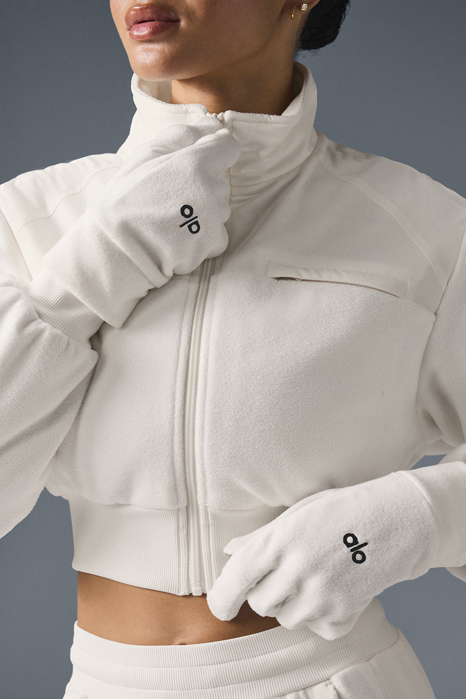 Close-up of ivory fleece gloves showcasing soft texture and warmth.