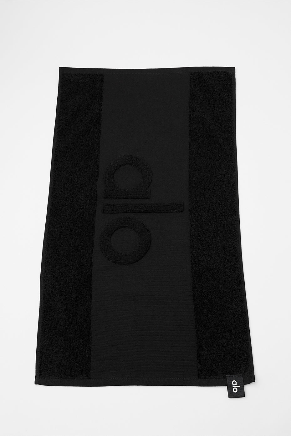 Black fitness towel folded on gym equipment.