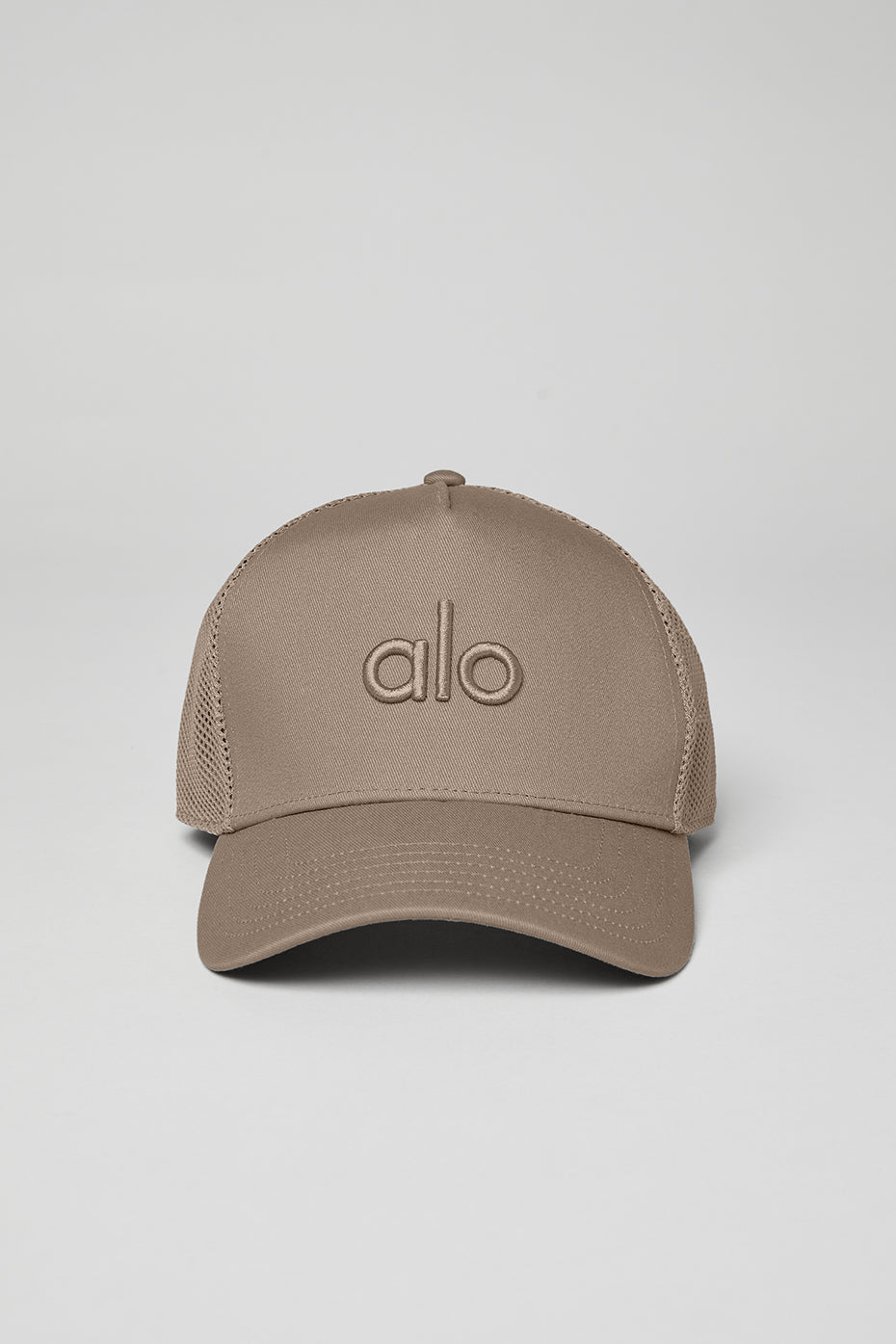 Outdoor setting featuring a person wearing a gravel trucker hat for casual style