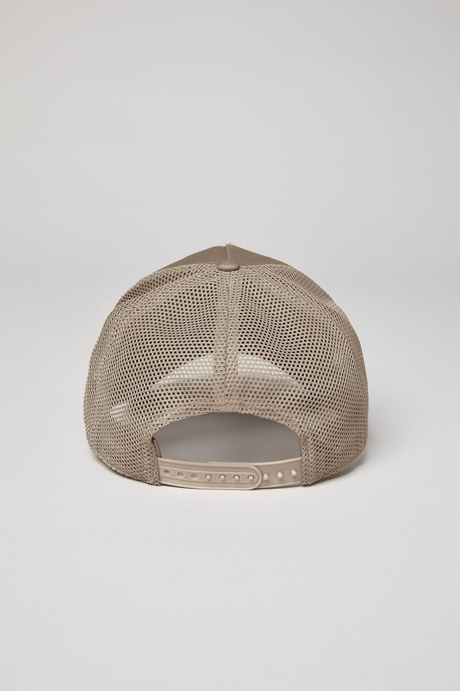 Side angle of adjustable snapback trucker hat in gravel color