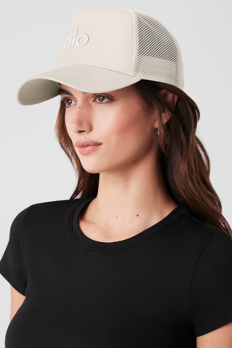 Front view of the Elevated District Trucker Hat in Bone with logo.