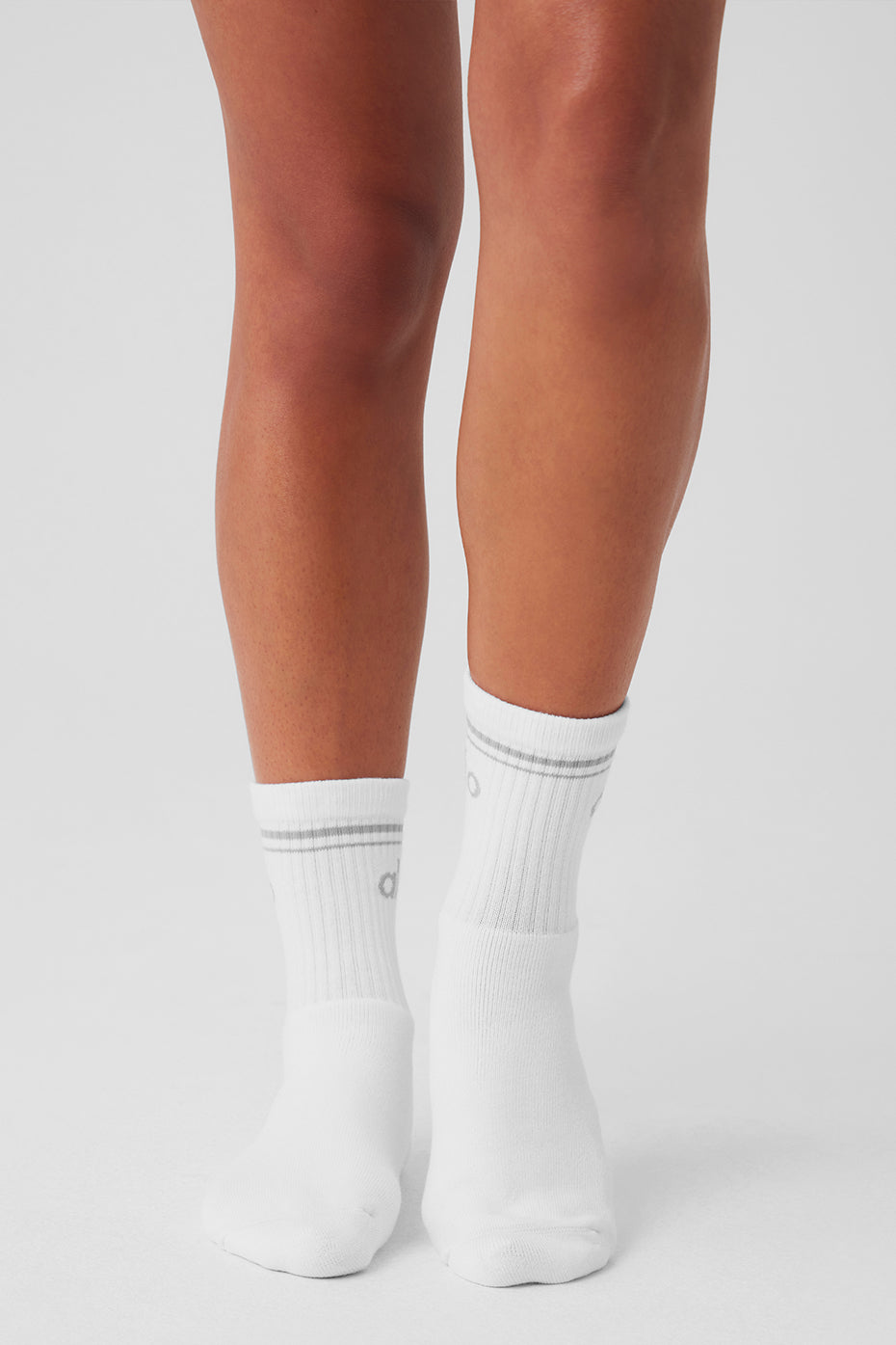 Side view of socks scrunched with leggings and sneakers for a retro-inspired style
