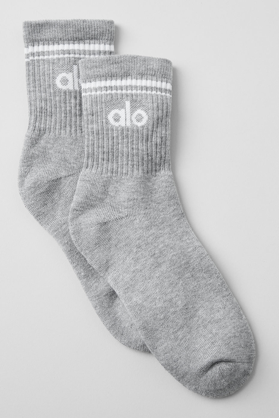 Close-up of athletic compression socks showing cushioned heel and toe in heather white finish