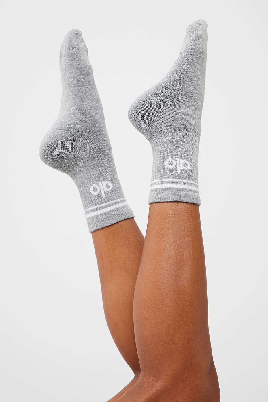 Close-up of athletic compression socks showing cushioned heel and toe in heather white finish