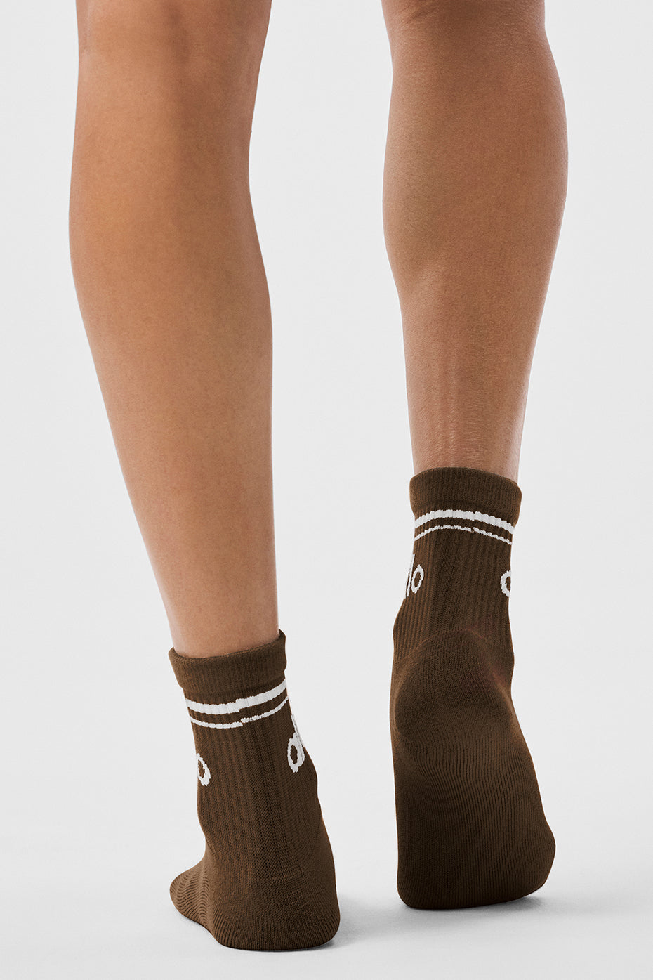 Model wearing retro crew socks with sneakers and shorts.