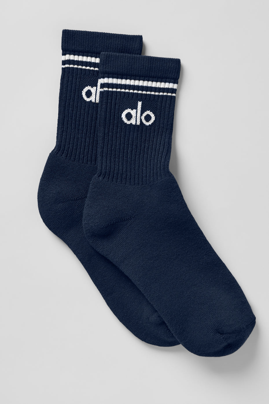 Close-up of navy and white retro crew socks on a wooden floor.