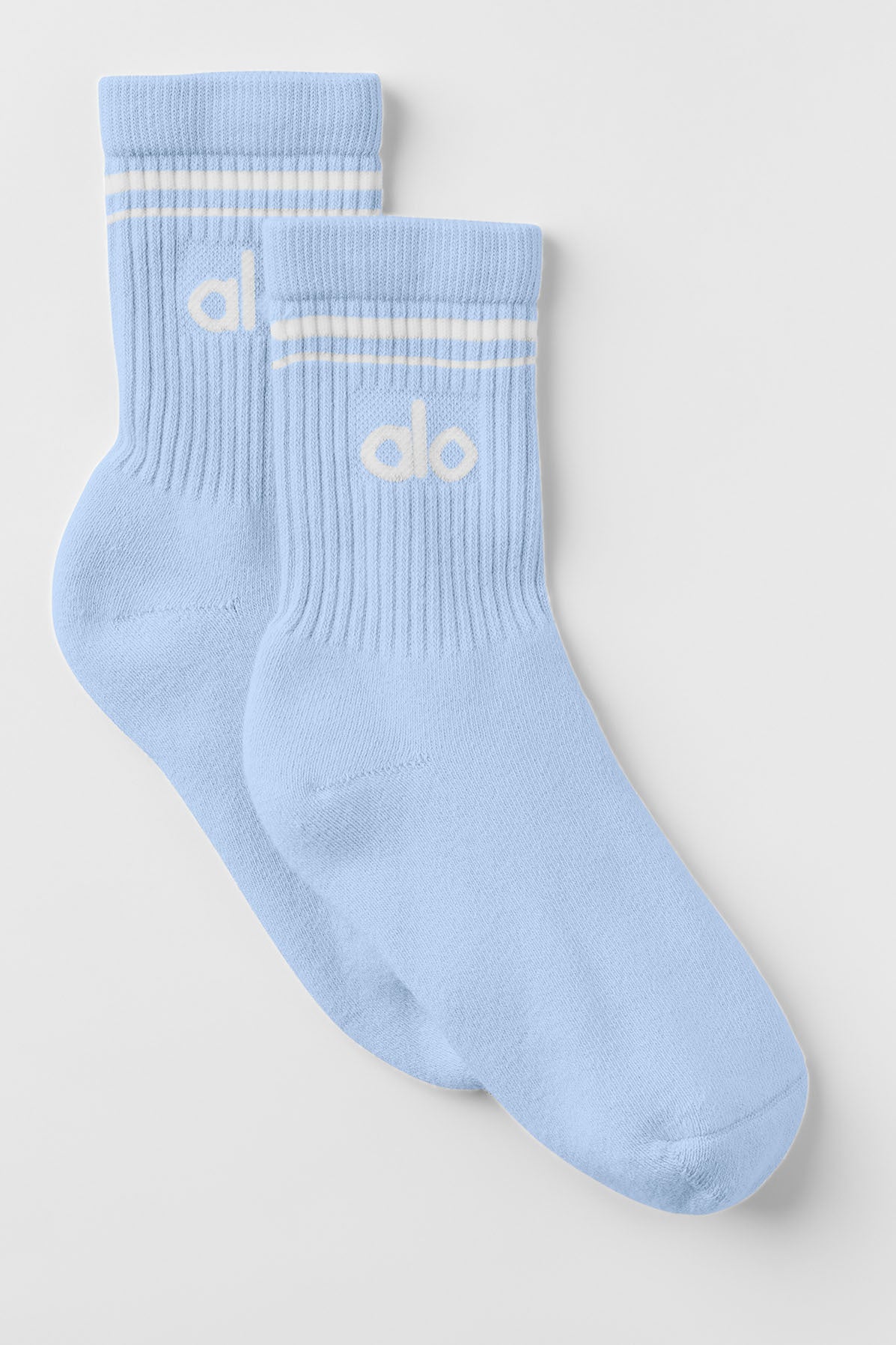 Close-up of seashell blue retro crew socks with stripes.
