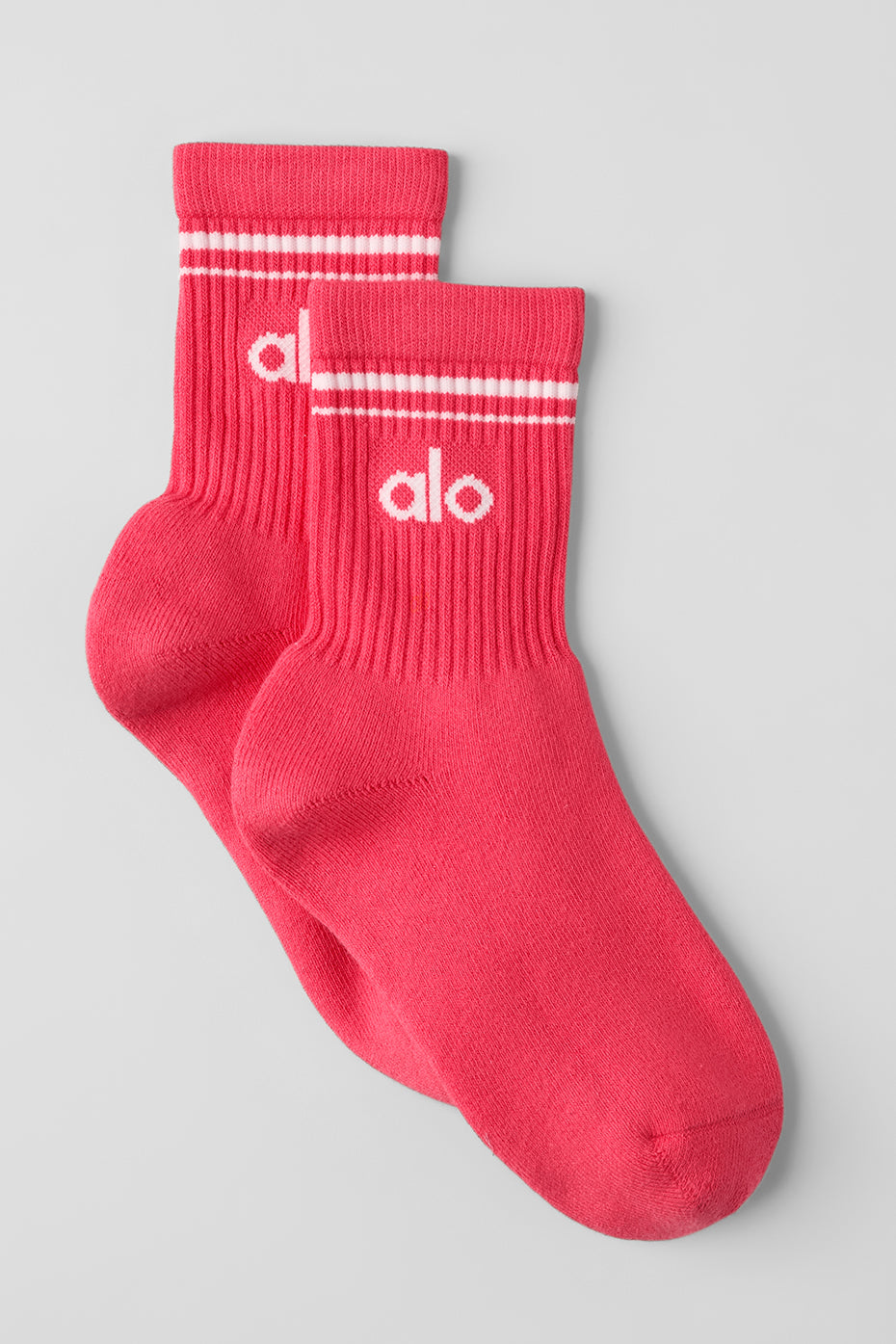 Retro-striped crew socks laid flat, showing vibrant candy red and white colors.