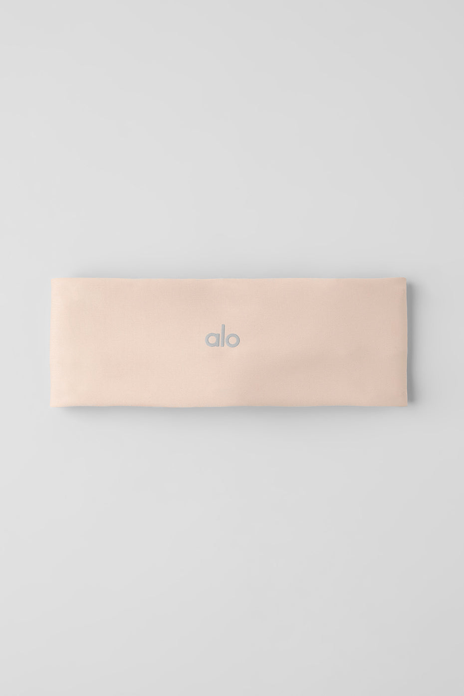 Headband laid flat showing stretchable material and slim profile