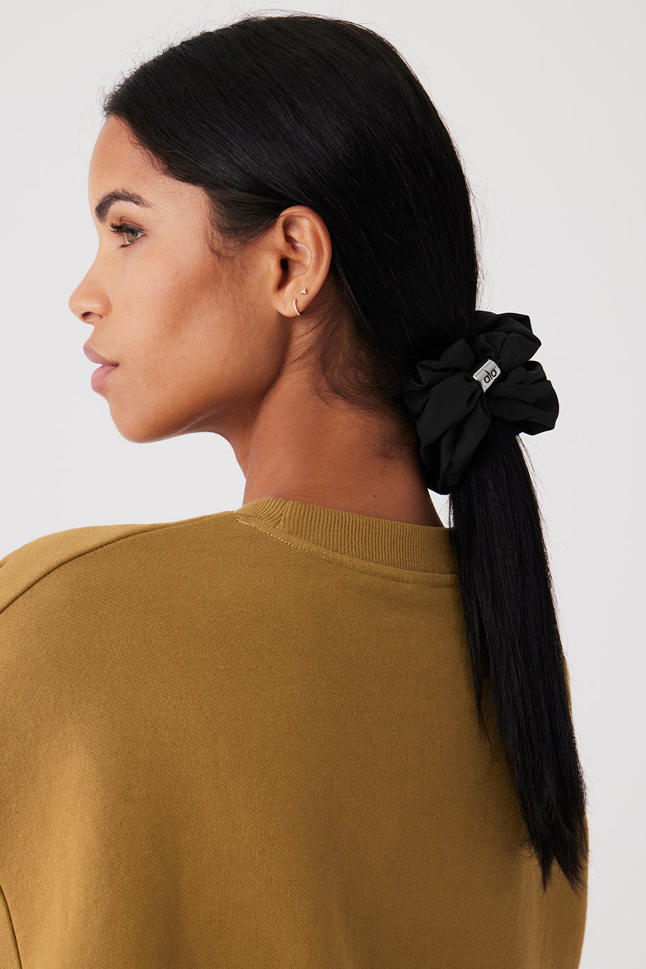 Model wearing the oversized black scrunchie in a casual hairstyle.