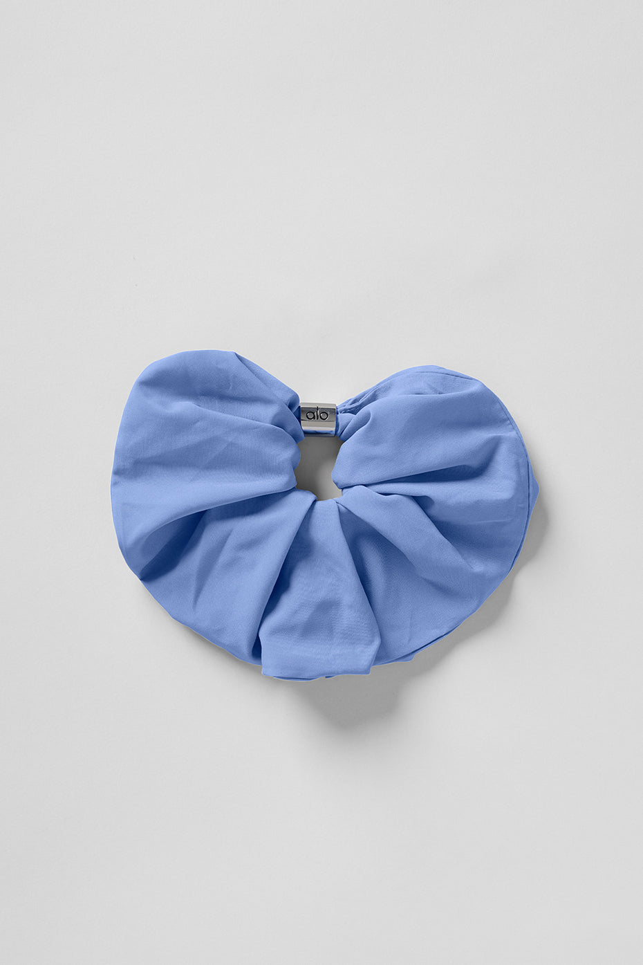 Close-up of the crystal clear blue oversized scrunchie with silver bead.