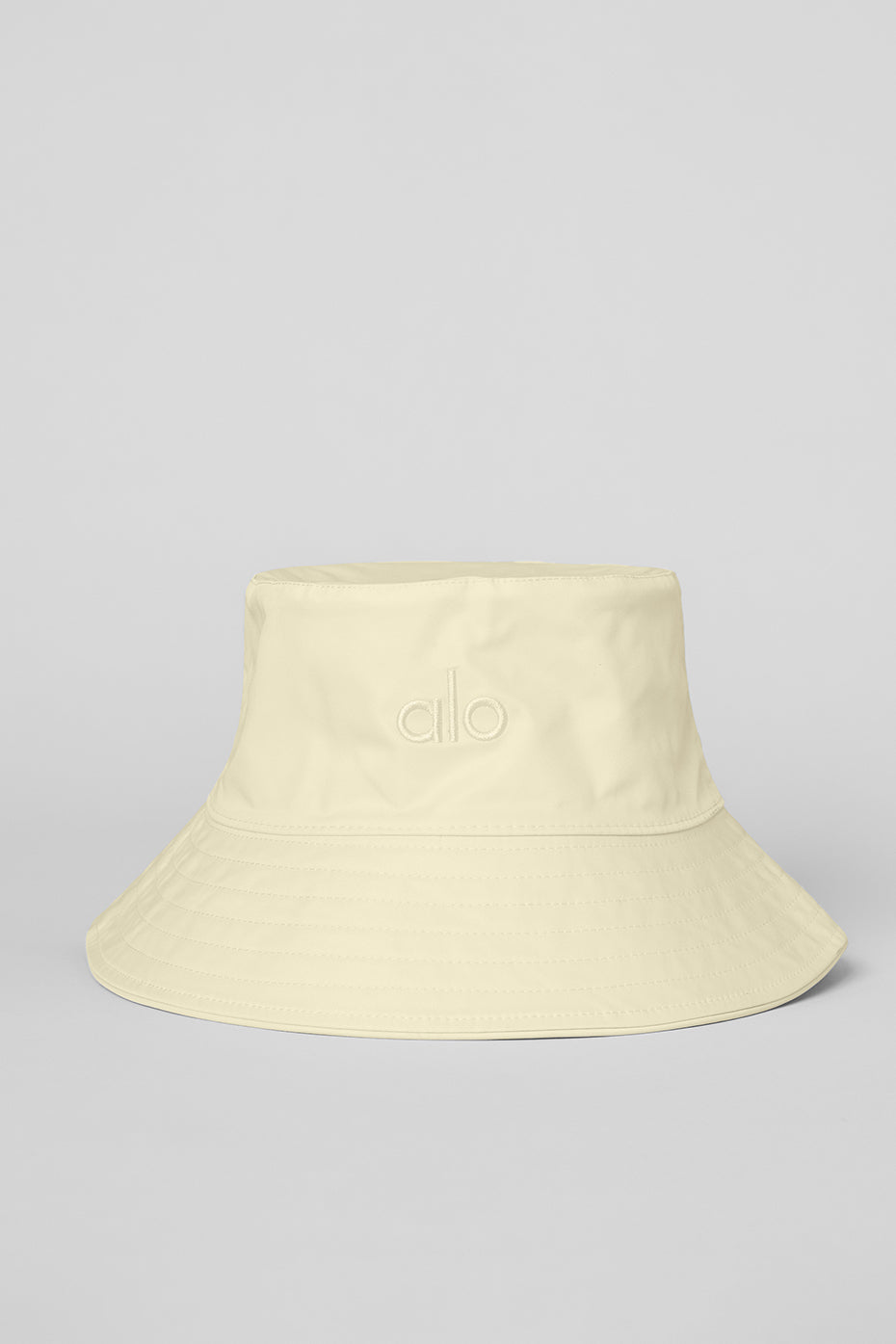 Lemon ice bucket hat on a sunny beach, showcasing its stylish design.
