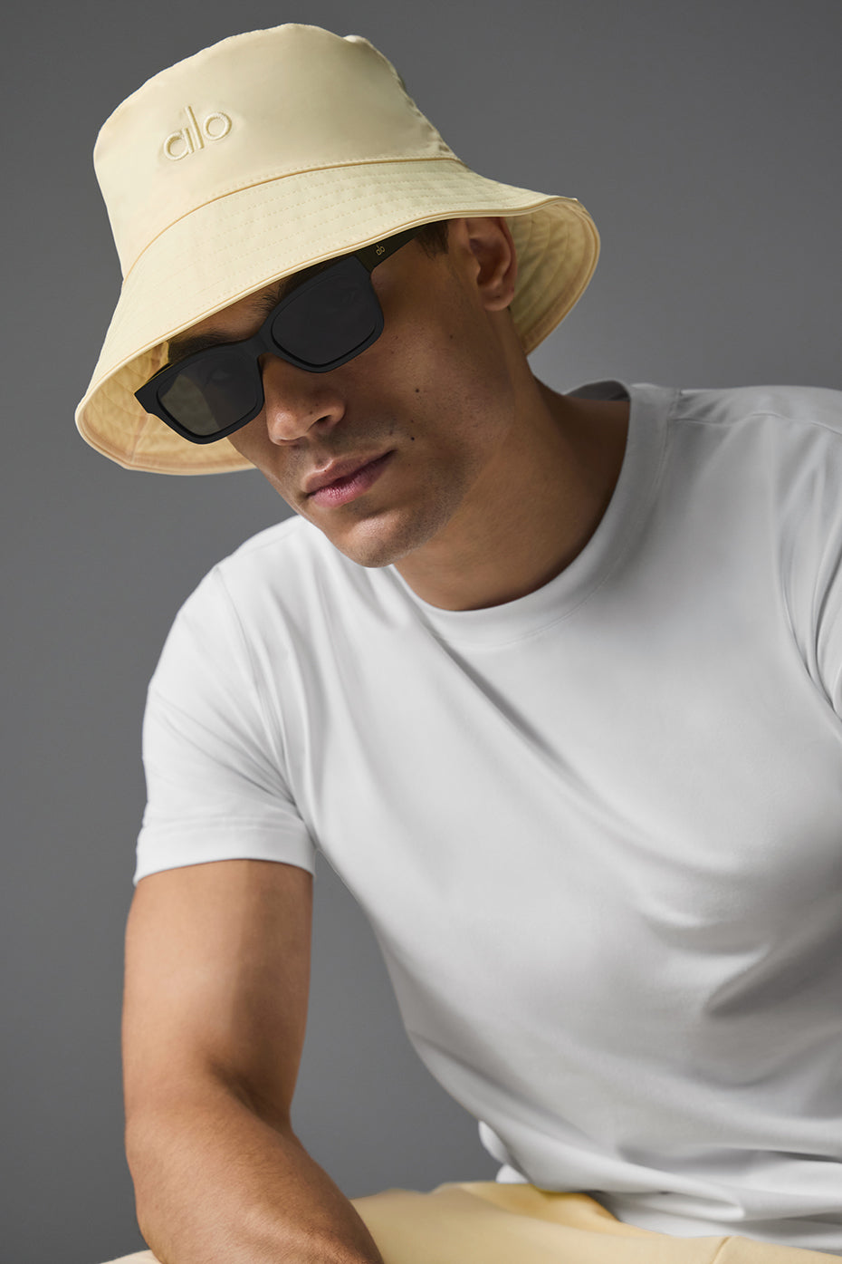 Man wearing a lemon ice bucket hat while enjoying a summer picnic.