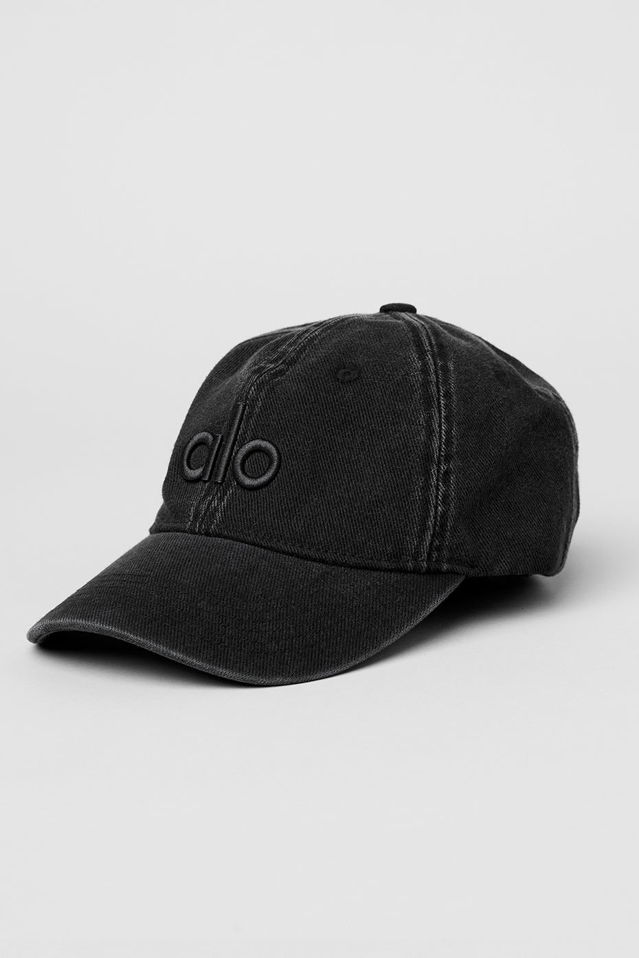 Vintage black baseball cap front view, showing tonal logo detail