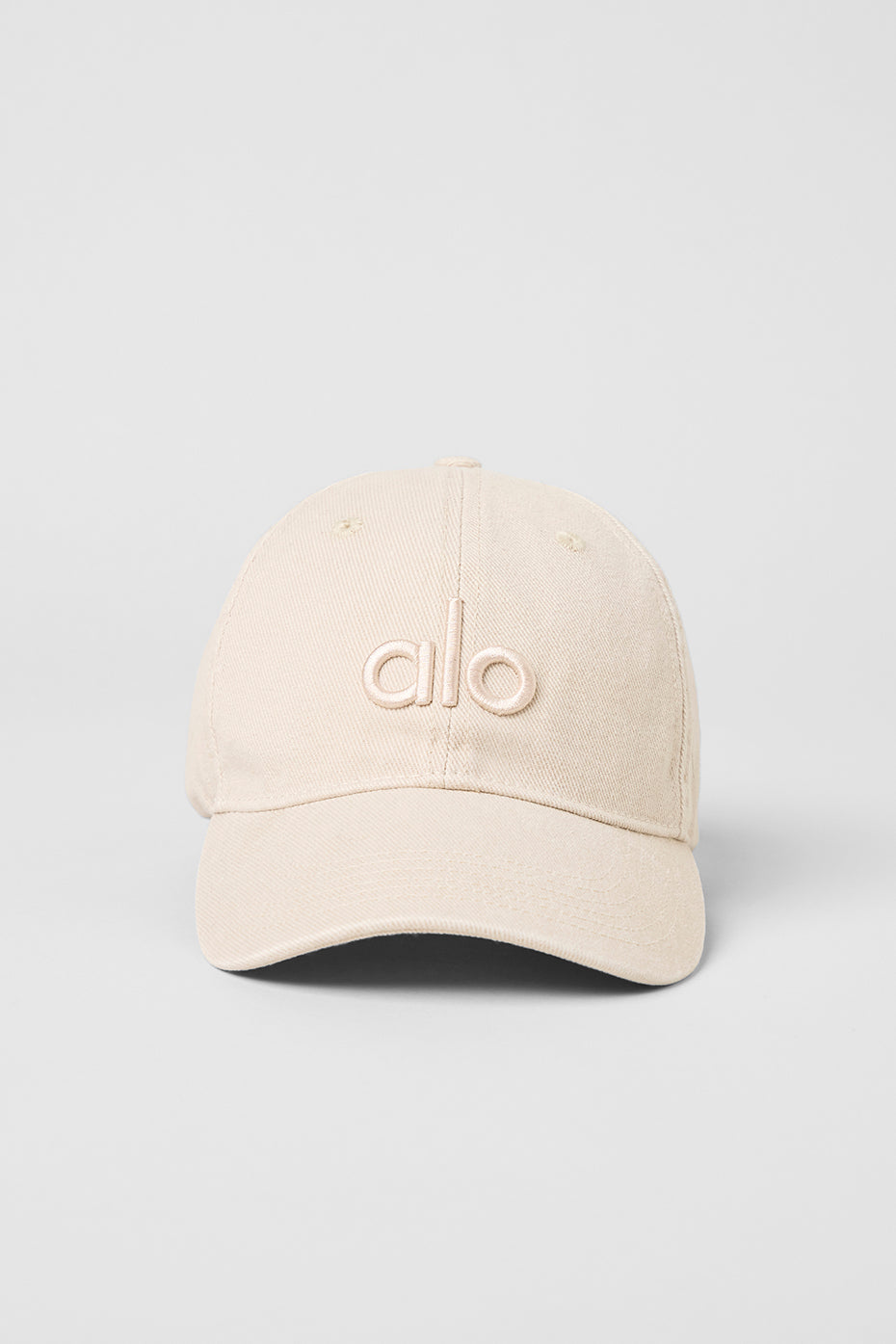 Lifestyle shot of a girl dad hat being worn at a sunny outdoor event.