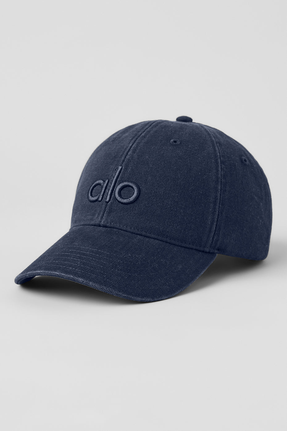 Close-up of washed navy vintage baseball cap showing tonal logo detail