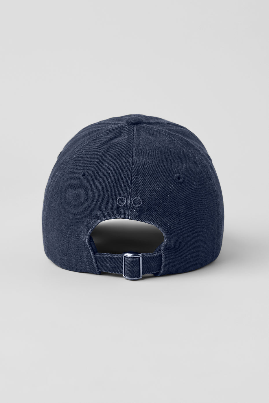Close-up of washed navy vintage baseball cap showing tonal logo detail