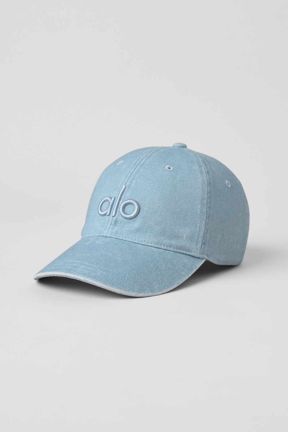 Close-up of adjustable buckle on washed denim cap