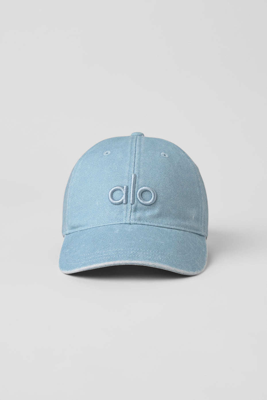 Side view of vintage denim dad hat on wooden bench