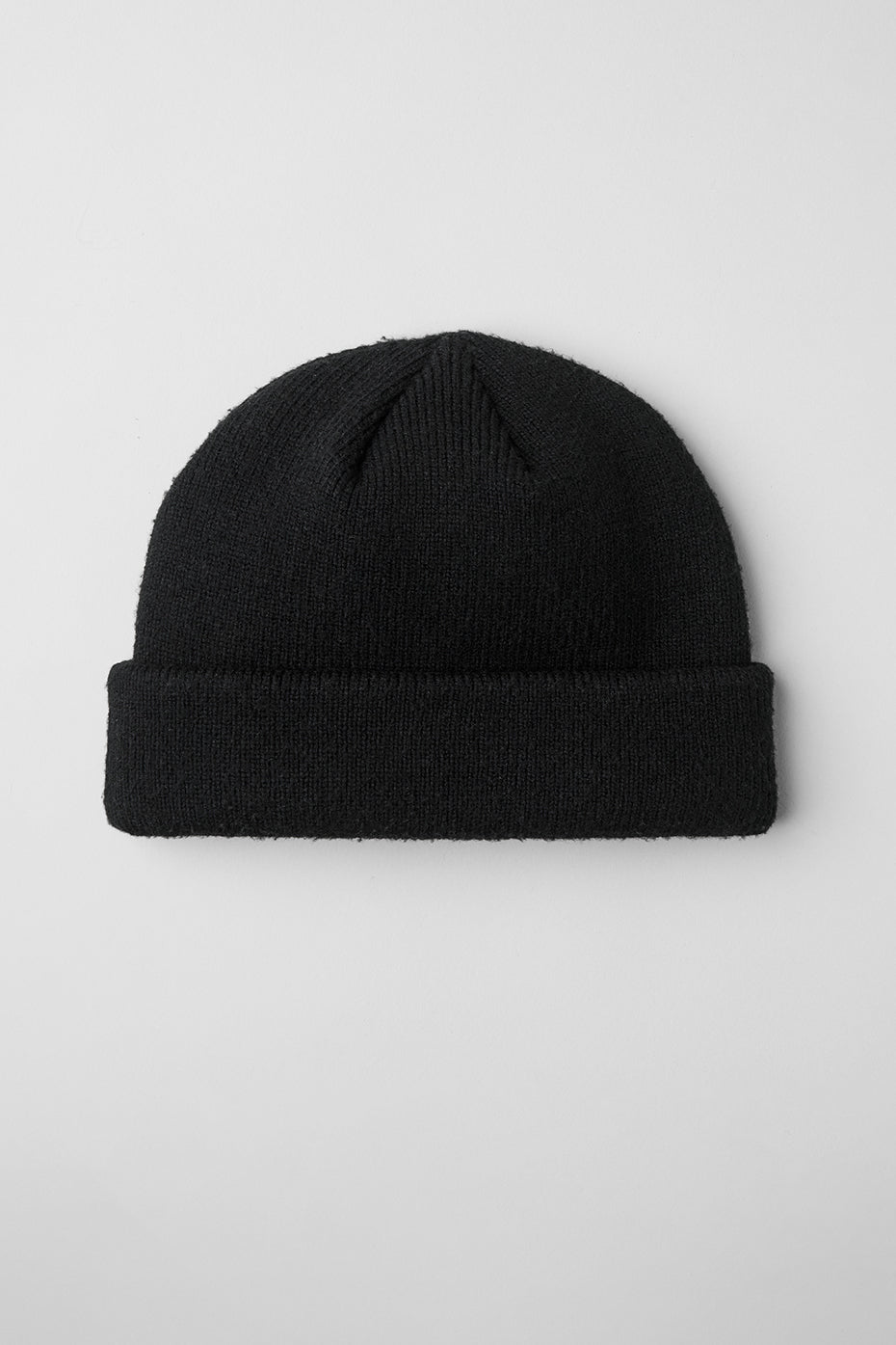 Model wearing a chic black beanie with winter attire.