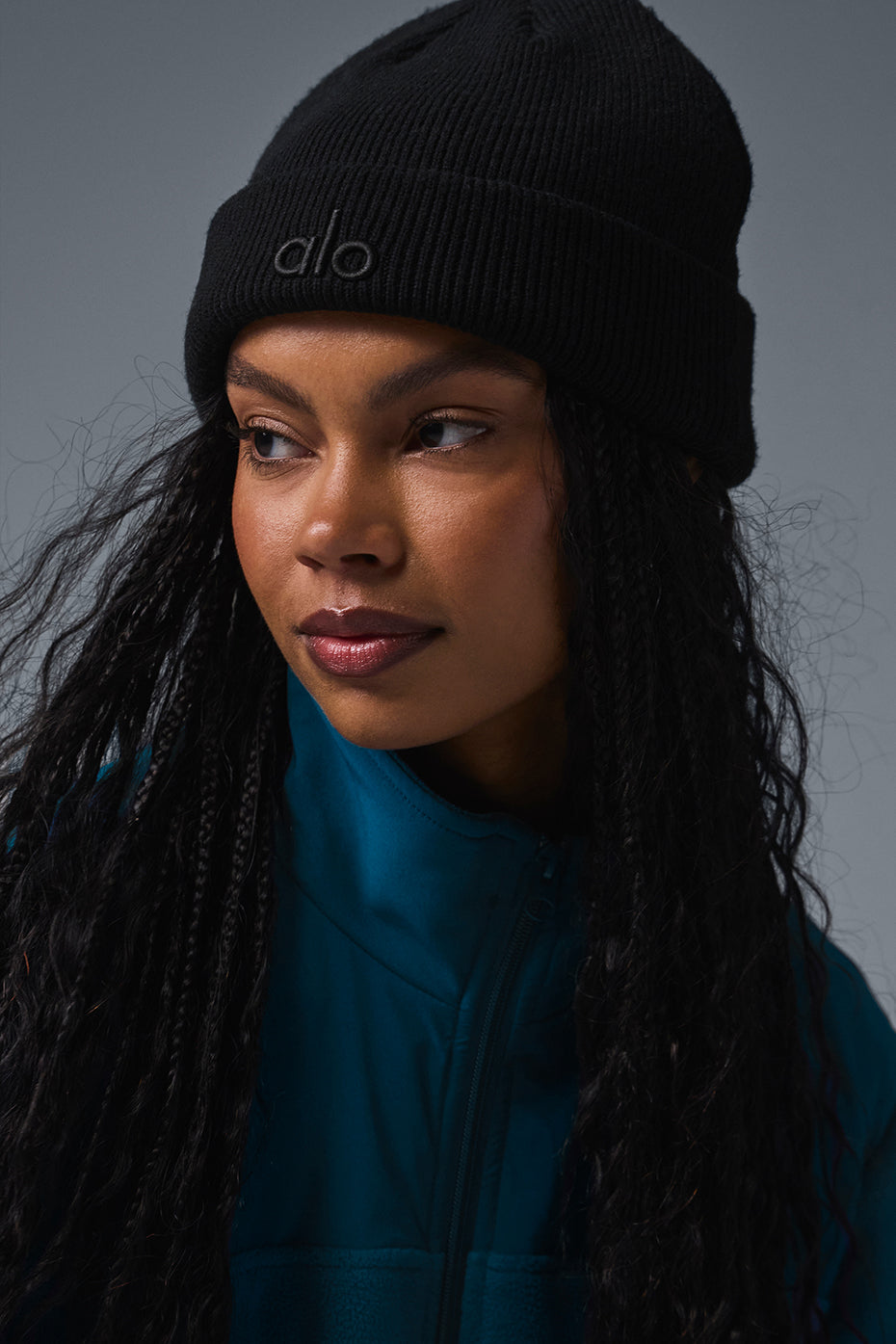 Close-up of the ribbed fabric and ALO logo on the chic beanie.