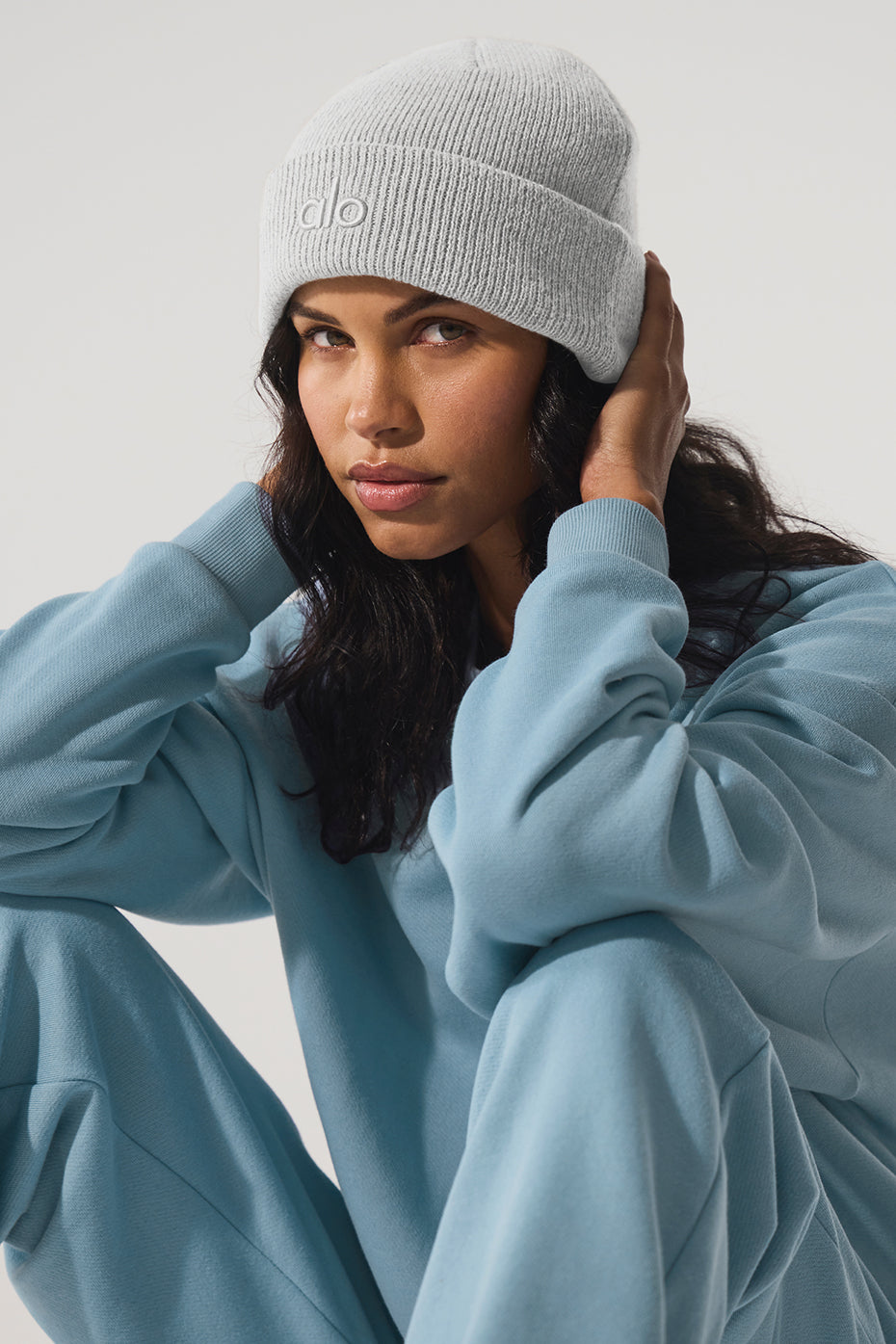 Athletic grey beanie hat styled with casual streetwear.