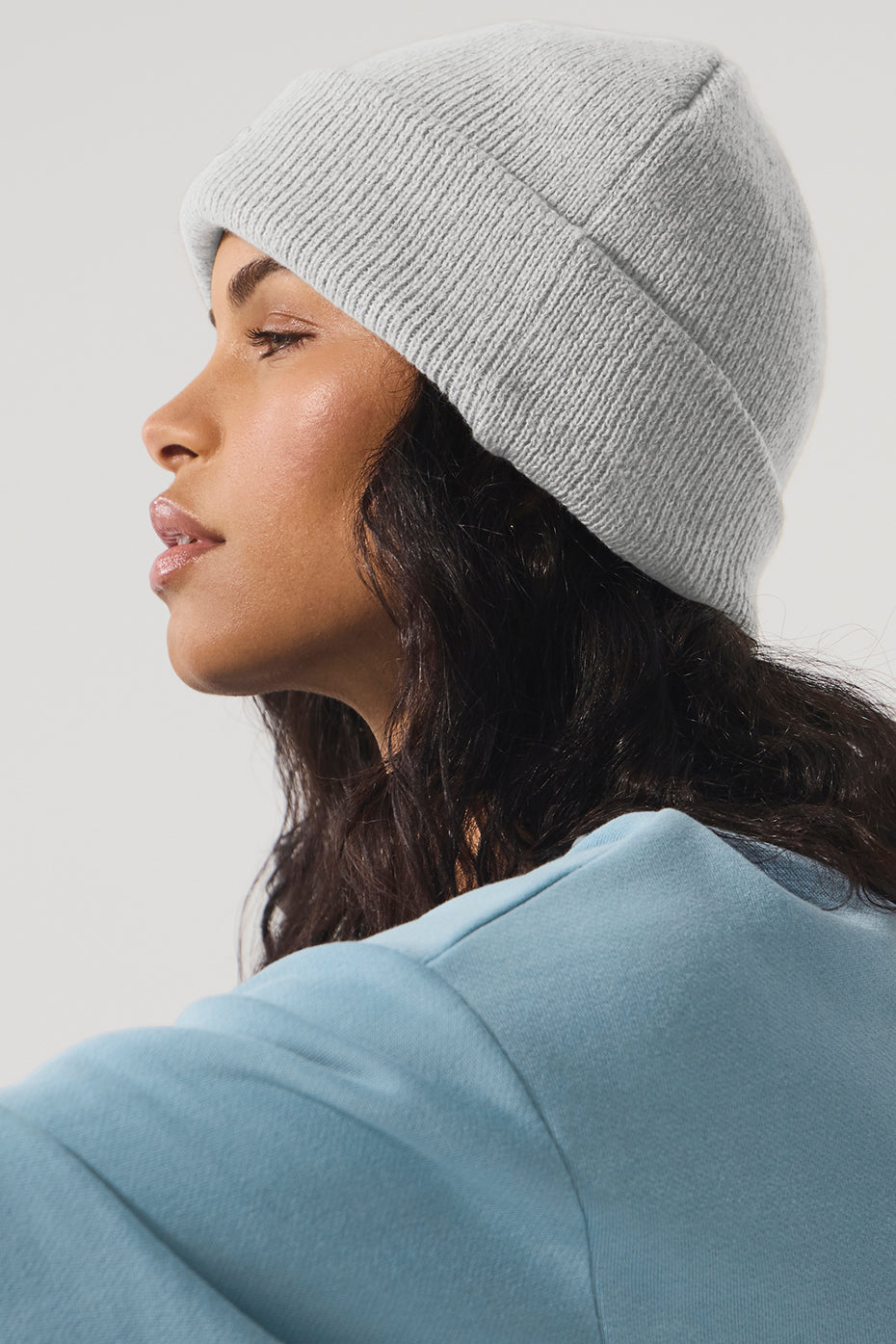 Model wearing the athletic grey beanie hat in a relaxed setting.