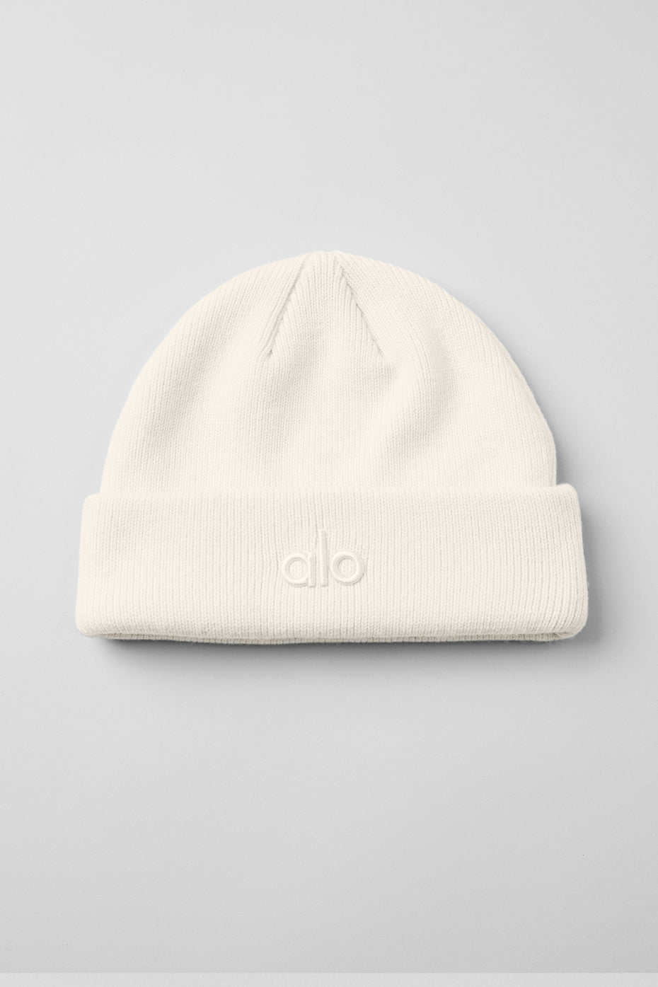 Close-up of ribbed beanie texture showing soft ivory knit details