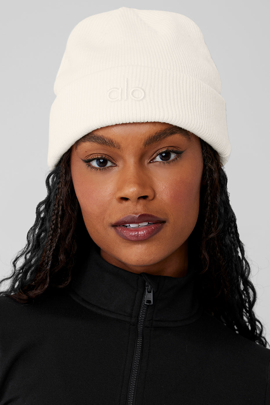 Front view of ivory beanie hat styled with a denim jacket