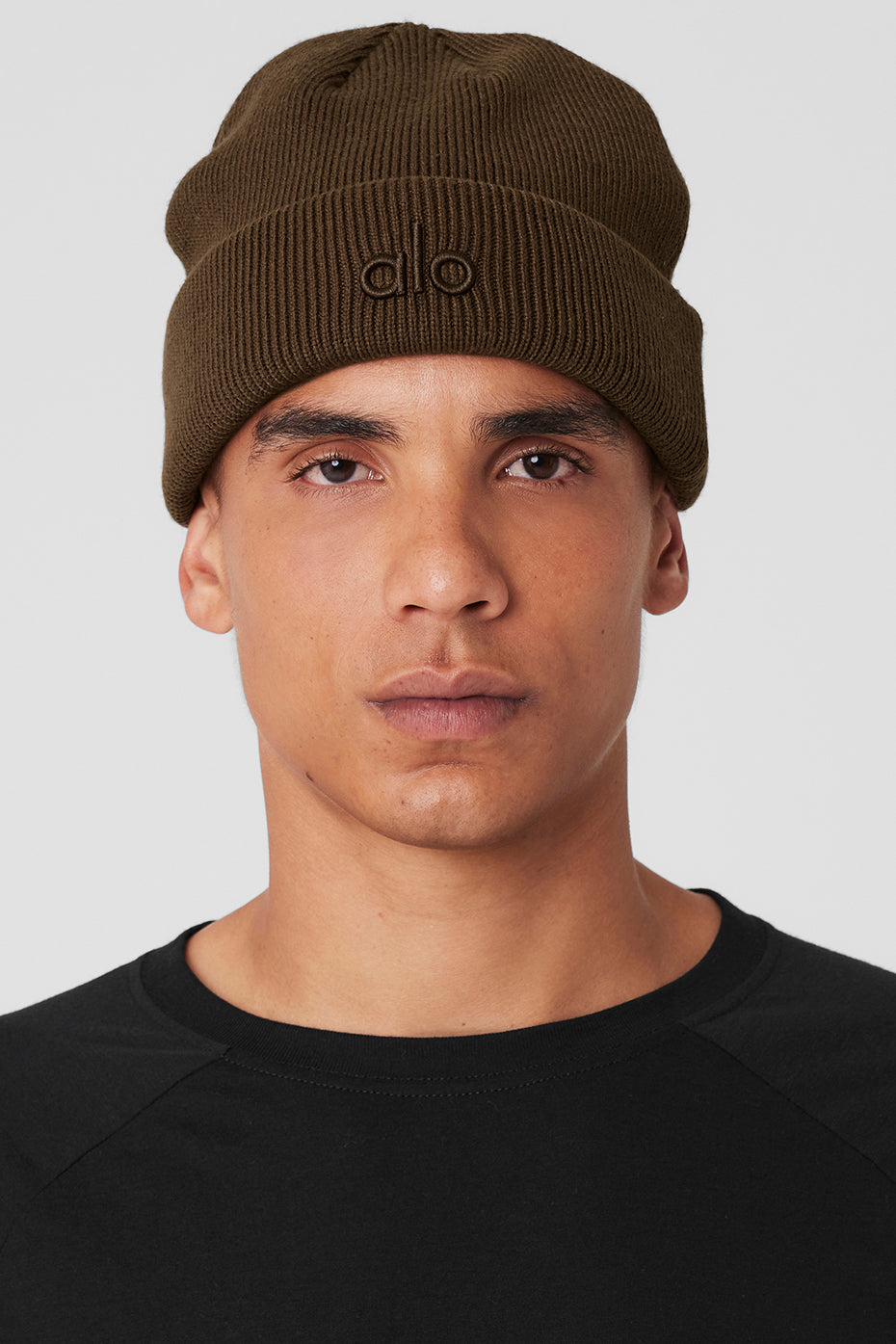 Espresso ribbed beanie worn outdoors on a chilly day.