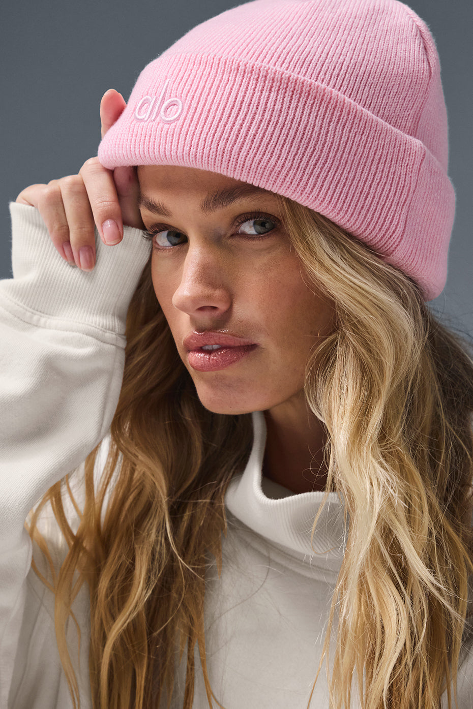 Front view of the sweet pink beanie featuring the ALO logo for a casual, streetwear look