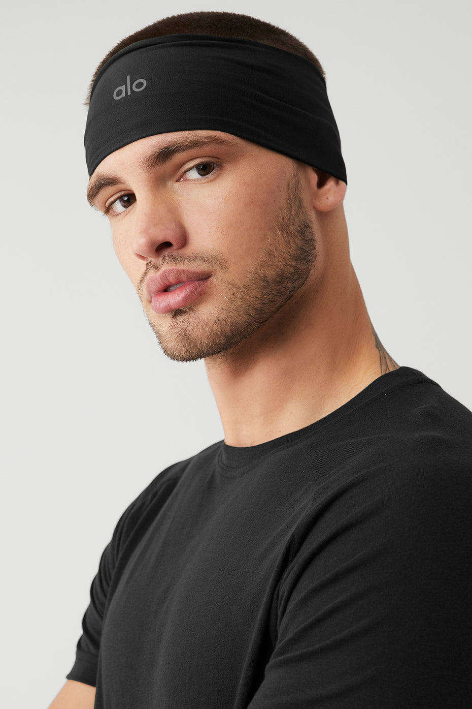 Close-up of the Ultimate Performance Headband in black, showcasing its moisture-wicking fabric.