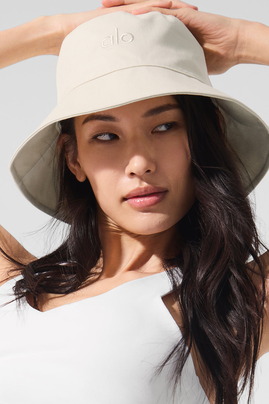 Model wearing the bucket hat at a sunny outdoor brunch.
